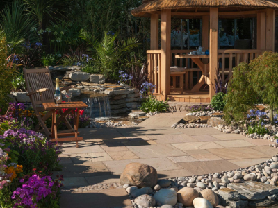 River rock garden path with vibrant plants